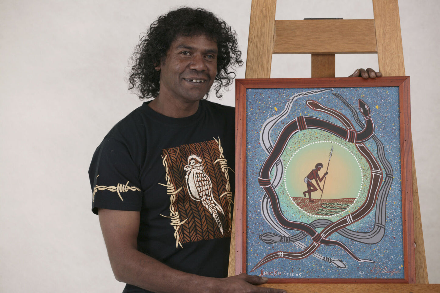 Lewis Langton standing next to his snake dreaming artwork