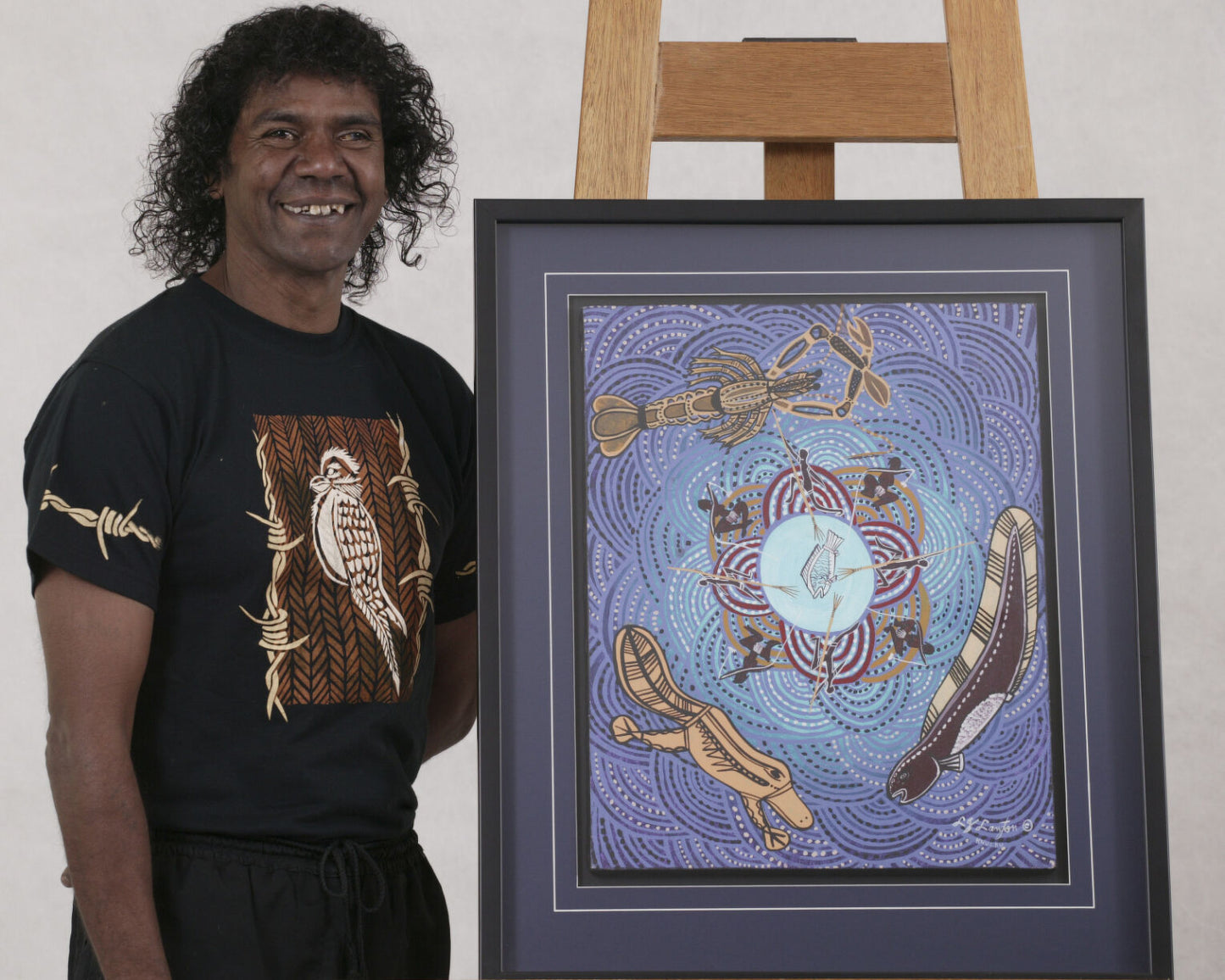 Lewis Langton standing next to his water dreaming artwork