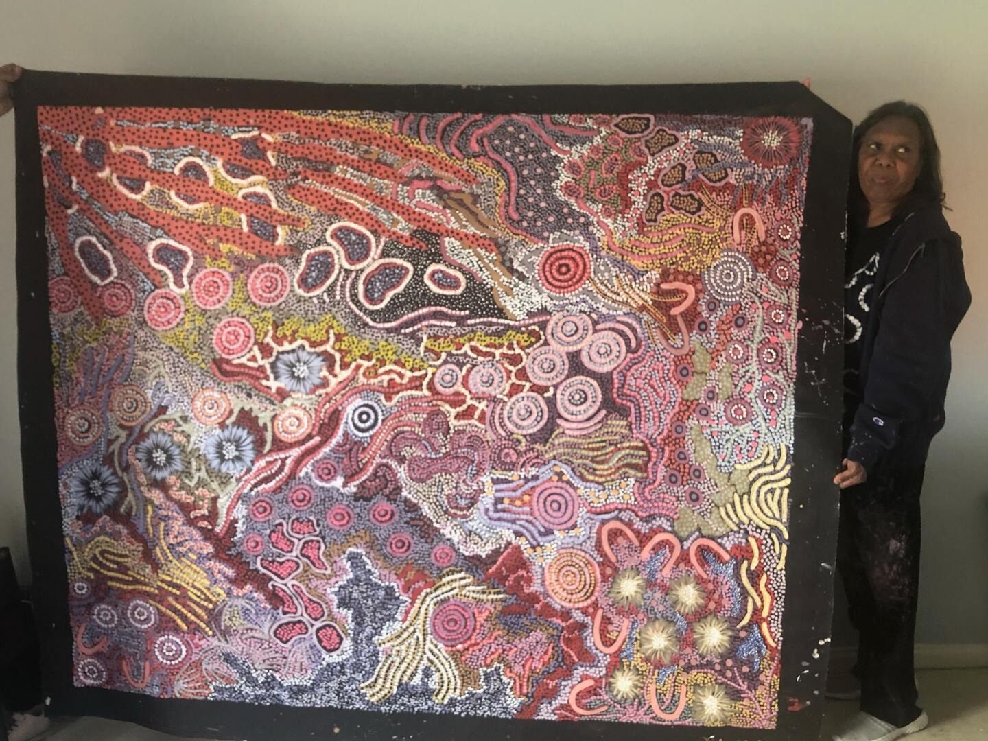 Gabriella Possum holding a large colorful Grandmothers Country