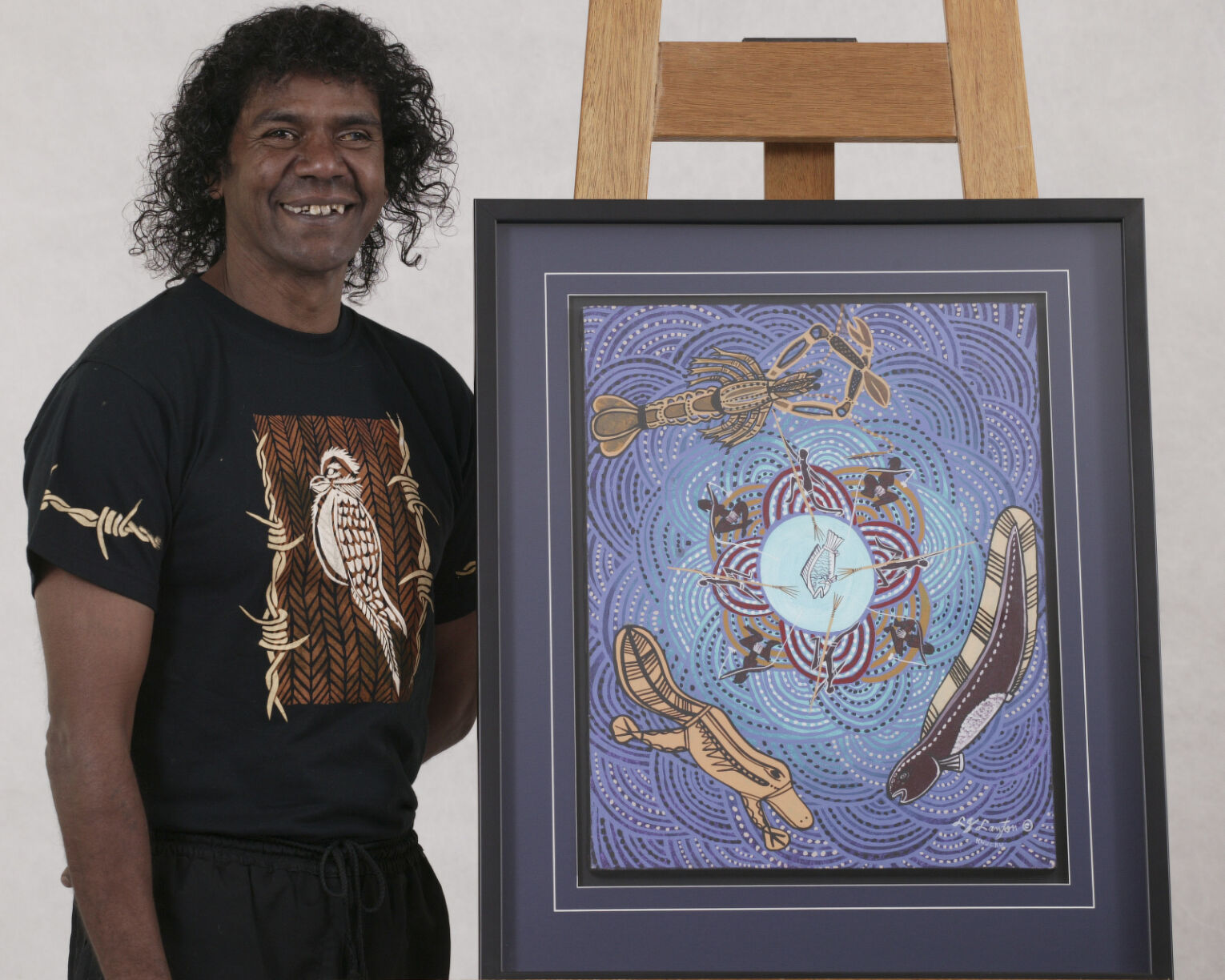 Lewis Langton standing next to his water dreaming artwork