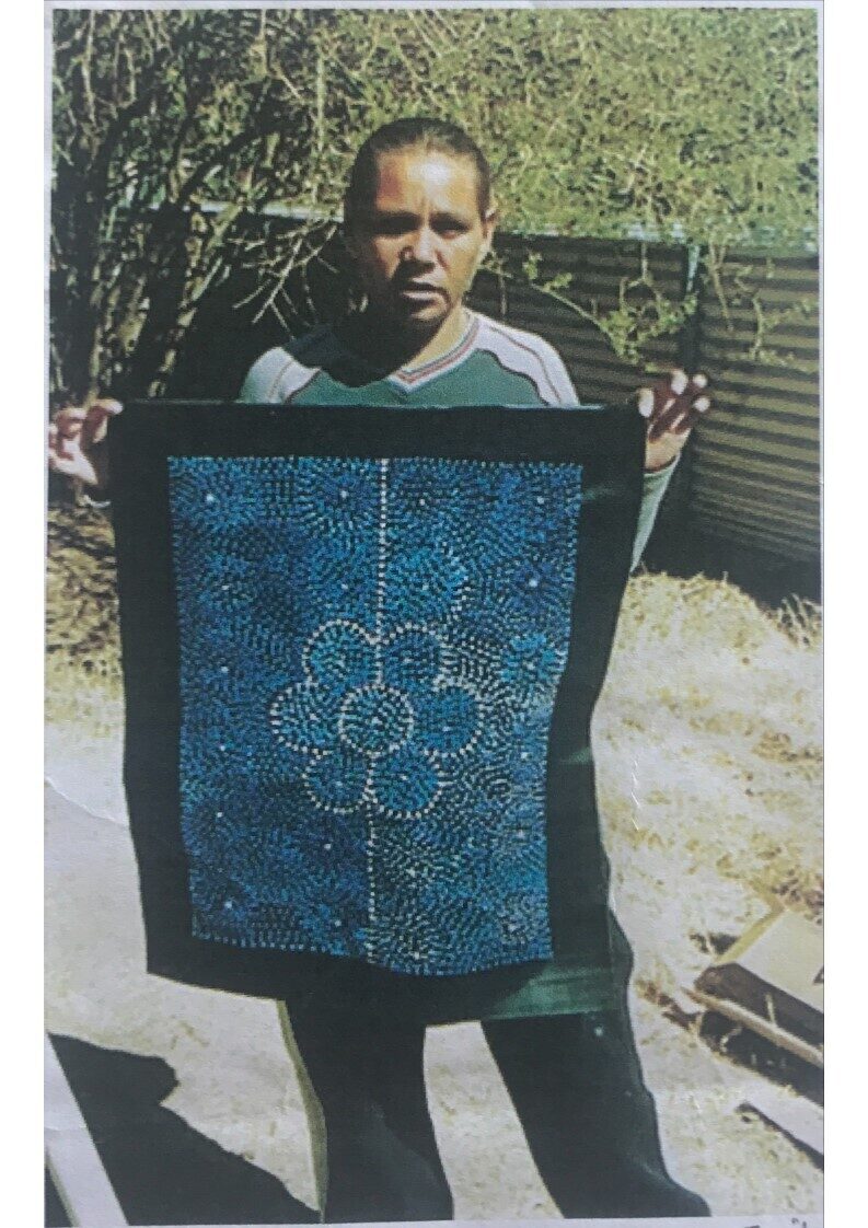 Marlene Coombe holing her seven sisters artwork