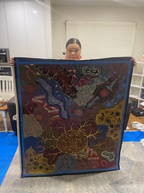 Nyrulla Possum holding Grandmothers Country artwork